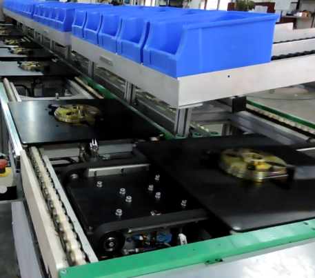Close-up of pallet conveyor with pallet lifter and part trays in transit
