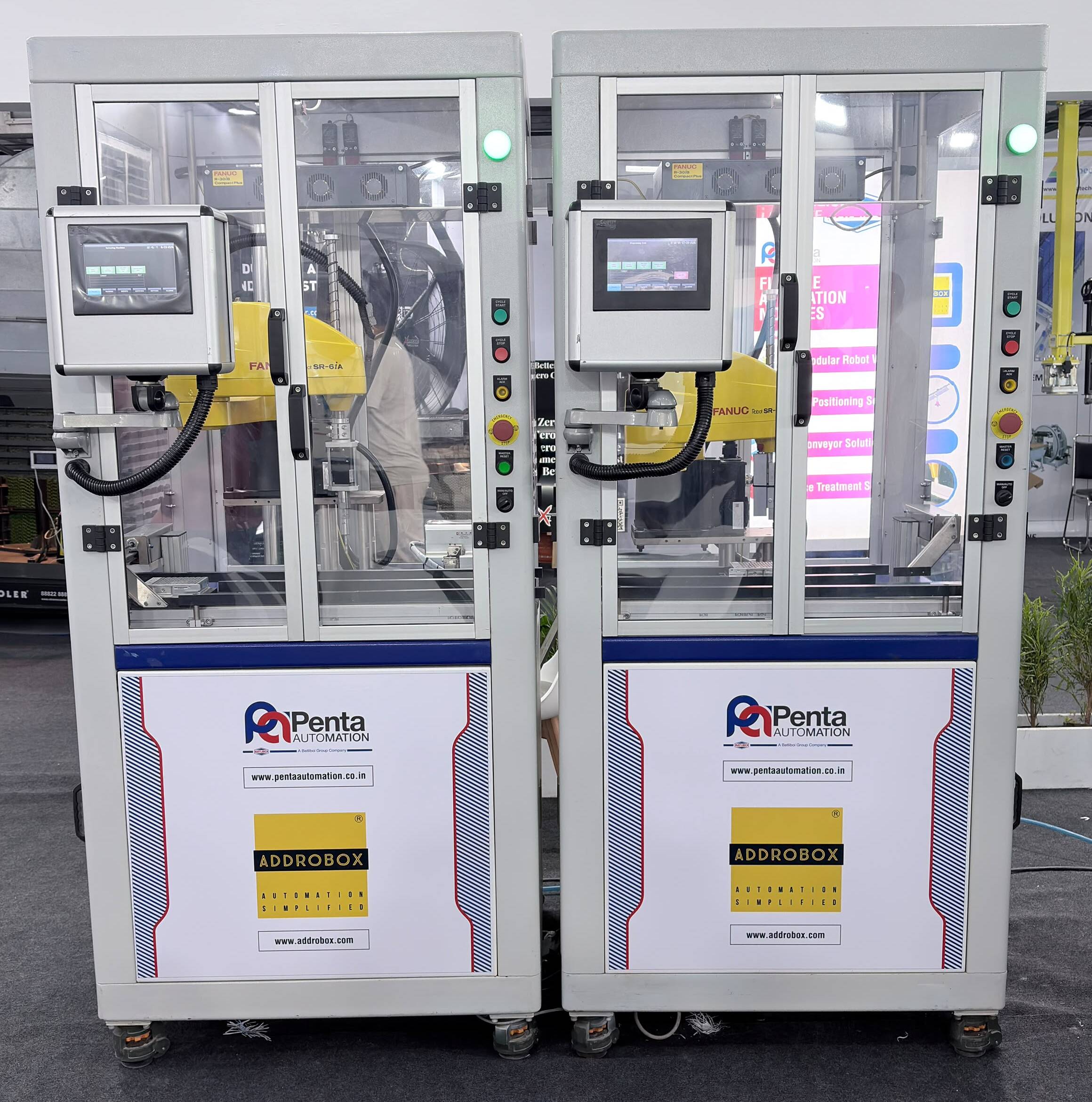 Two ADDROBOX modular robot cells joined into a production line